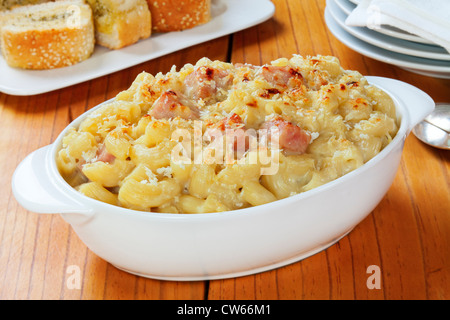 Macaroni Cheese with ham, served with garlic bread. A great way to use up your Christmas ham. Stock Photo