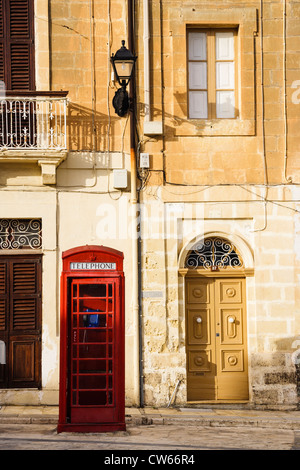 British telephone booth and traditional doors at Marsaxlokk, Malta Stock Photo