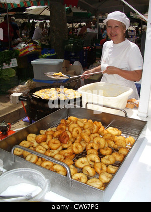 woman cooking typical majorcan snacks Bunuelos  on the market, Spain, Balearen, Majorca, Alcudia Stock Photo