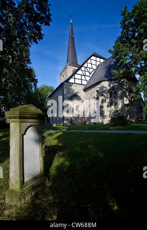 1000 years old Stiepeler Dorfkriche with gravestone in the foreground, Germany, North Rhine-Westphalia, Ruhr Area, Bochum
