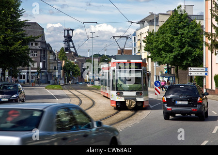 traffic in the the district Wattenscheid with the shaft tower of the former coal mine Holland, Germany, North Rhine-Westphalia, Ruhr Area, Bochum Stock Photo