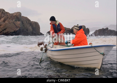 Young boy and old man fishing together in south-western Norway, Norway, Flekkefjord Stock Photo