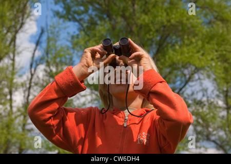 boy with binoculars watching birds, Germany Stock Photo