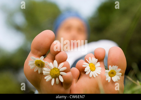 feet with flowers between the toes Stock Photo