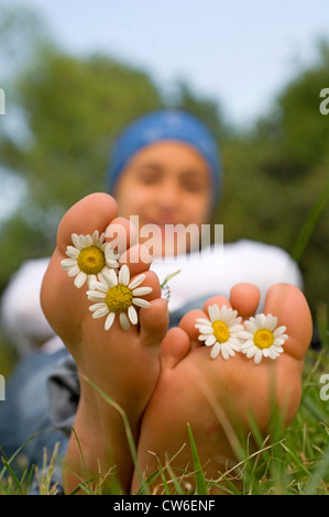 feet with flowers between the toes Stock Photo