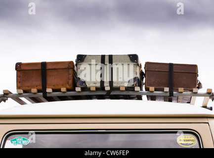 Three old suitcases on an old VW campervan. Stock Photo