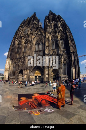 street painting and Buddhist in front of Cologne Cathedral, Germany, North Rhine-Westphalia, Koeln Stock Photo