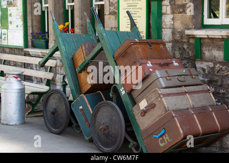 old fashioned luggage, suitcases and porters trolleys at Swanage Railway station Dorset England UK Stock Photo