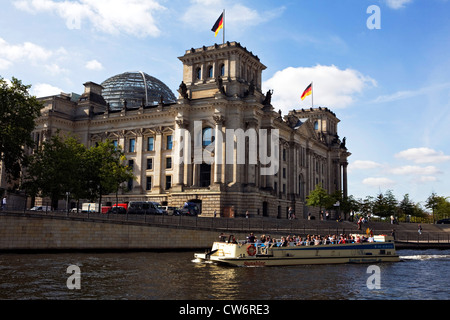 tourist ship on Spree river at Berlin Reichstag, Germany, Berlin Stock Photo