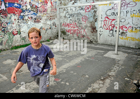 boy on a football area with graffiti, Germany, North Rhine-Westphalia, Cologne Stock Photo