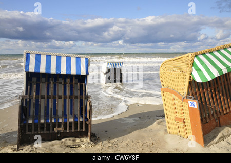 beach chairs at the sand beach, some standing in the surf, Germany, Mecklenburg Vorpommern, Ostsee Stock Photo