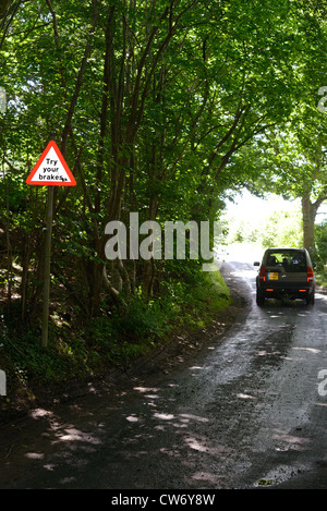 four wheel drive vehicle passing try your brakes warning sign after ford across road Bardsey Yorkshire UK Stock Photo