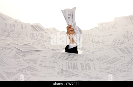 business man bogging in a heap of text documents with only one arm looking out Stock Photo