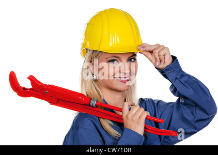 young woman with blue working outfit and pipe wrench Stock Photo