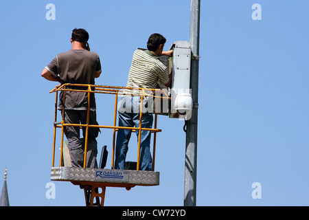 electrician with street lightening on a lifting platform Stock Photo