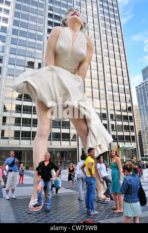 USA Illinois Chicago Tourists by the 26-foot-tall statue of Marilyn Monroe Pioneer Court along Michigan Avenue downtown Chicago. Stock Photo