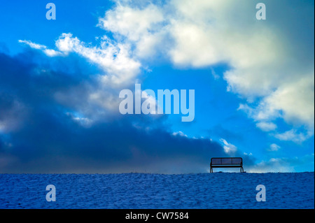 bench on top of a snow-covered North Sea dyke, Germany, Lower Saxony, Landkreis Cuxhaven, Dorum-Neufeld Stock Photo