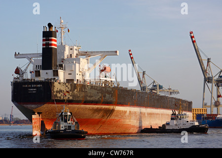 transport ship with towboats in Port of Hamburg, Germany, Hamburg Stock Photo