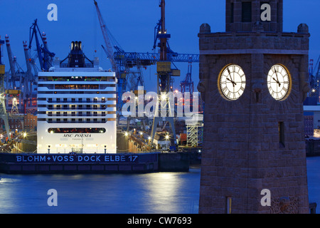 Cruise Ship in the Dock with tower clock in the fore ground, Germany, Hamburg Stock Photo