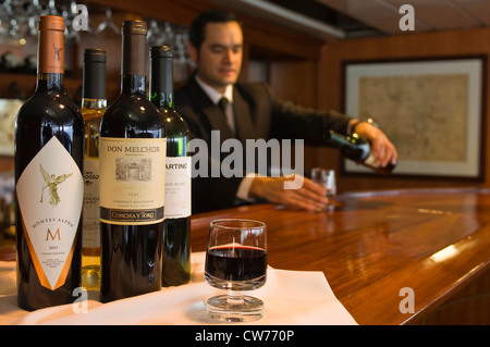 serving Chilean wine onboard the Antarctic Dream, Antarctica Stock Photo