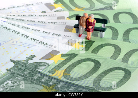 symbolic picture for pesion and provision for one's old age, little figures on bank notes Stock Photo