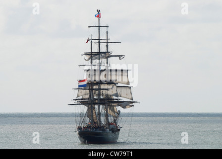 two sailors sitting on mast top of tall ship, Netherlands, Den Helder Stock Photo