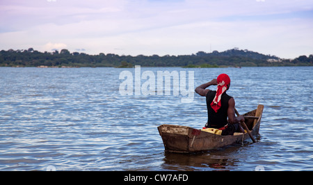 Muscular young fisherman riding his boat on Lake Kivu, Uganda, Entebbe Stock Photo