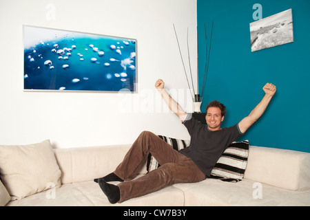 young man relaxing on couch in living room