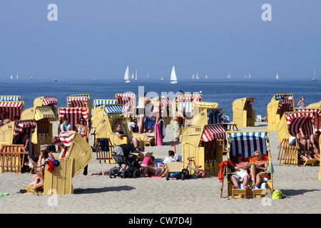 bathers in beach chairs on the sunlit Baltic Sea beach , Germany, Schleswig-Holstein, Travemuende, Luebeck Stock Photo