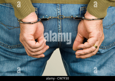 Closeup of hands in handcuffs Stock Photo