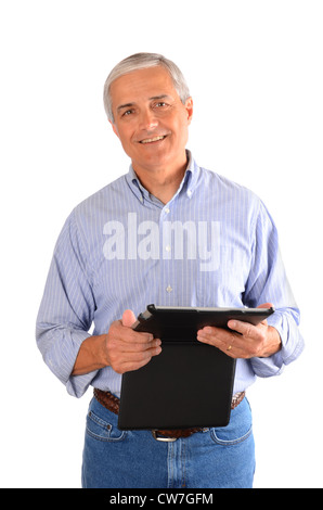 A casually dressed businessman holding a tablet computer in a case. Vertical composition over a white background. Stock Photo