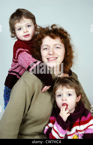 portrait of a mother with her twins Stock Photo