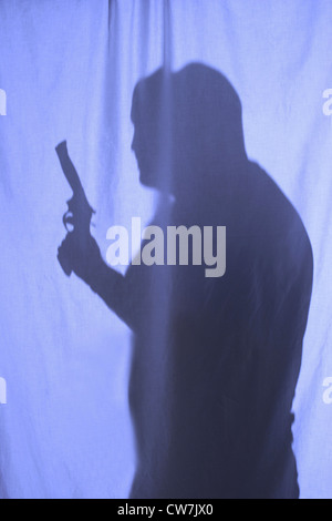 man with weapon behind a curtain Stock Photo