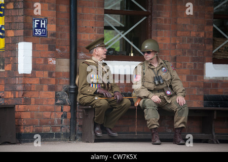 Soldiers talking on platform - sitting Stock Photo