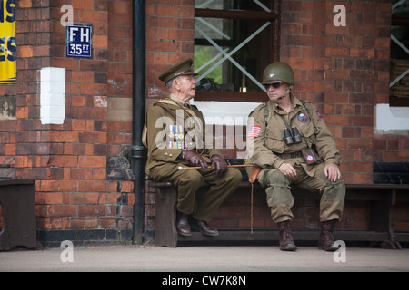 Soldiers talking on platform - sitting Stock Photo
