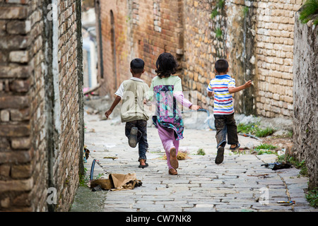 Kids running in an alley, Said Pur Village, Islamabad, Pakistan Stock Photo