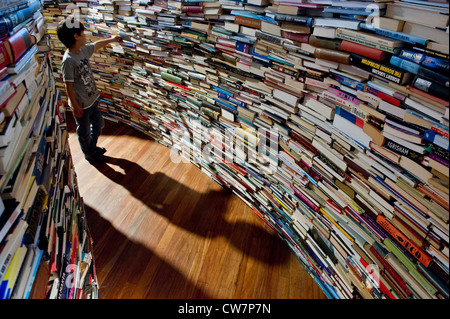 Created by Marcos Saboya and Gualter Pupo, aMAZEme immerses the audience in a labyrinth of books. Stock Photo