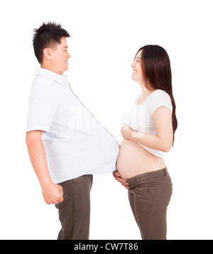 pregnant woman and man with football under shirt Stock Photo