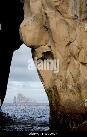 Ecuador, Galapagos. View of Kicker Rock (aka Leon Dormido) through a cave from San Cristobal. Stock Photo
