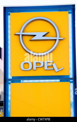 Broken Opel signboard (L is falling down) in Agios Nikolaos on Crete Island in Greece on August 5, 2012. Stock Photo