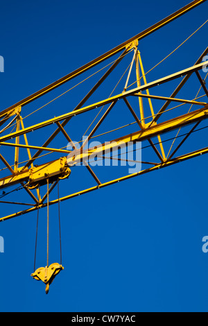 A yellow crane jib against a vivid blue sky, Vancouver, Canada Stock Photo