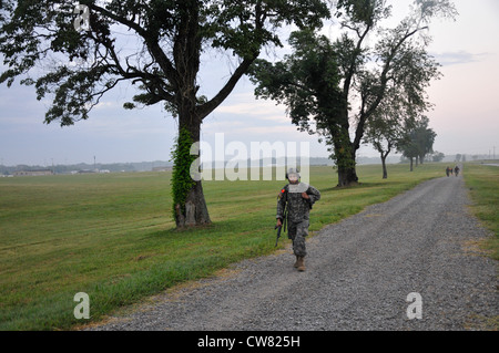 A soldier with the 101st Airborne Division (Air Assault) sets the pace during a 12-mile road march in the Toughest Air Assault Competition held, Aug. 15, at the Sabalauski Air Assault School in Fort Campbell. The competition is part of the Week of the Eagles 2012, a celebration of the Screaming Eagles. Stock Photo