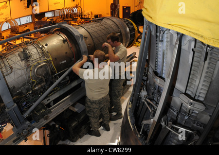 Air National Guard propulsion shop members, 173rd Fighter Wing, prepare to transport a F-15 engine into the hangar at Kingsley Field, Ore., Aug. 14, 2012. The F-15 engines are maintained and upgraded by the propulsion shop members on base. Stock Photo