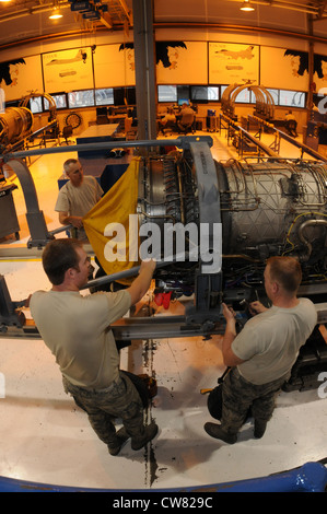 Air National Guard propulsion shop members, 173rd Fighter Wing, prepare to transport a F-15 engine into the hangar at Kingsley Field, Ore., Aug. 14, 2012. The efficiency and skill of the propulsion shop on base contributes to the great success of the 173rd Maintenance Group. Stock Photo