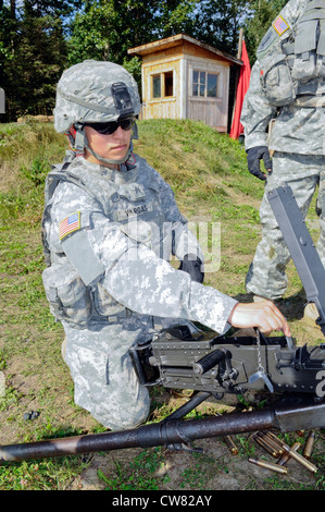 Sgt. Yesenia Vargas, 95th Chemical Company, 2nd Engineer Brigade, of Los Angeles, sets the headspace and time on the M2 .50 caliber machine gun at the Temporary Machinegun Range, JBER-Richardson, Tuesday, Aug. 14, 2012. Army machine gun marksmanship is based on the concept that soldiers must be able to effectively apply their firing skills in combat. Teams, consisting of a gunner and assistant gunner, underwent basic non-firing training covering maintenance and immediate action drills and an initial 10-meter live fire grouping/setting course, and weapons qualification. Stock Photo