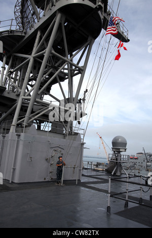 A sailor hoists the colors as the USS Rushmore leaves Naval Base San Diego, Calif., to begin the 15th Marine Expeditionary Unitâ€™s Certification Exercise, Aug. 15. The CERTEX is the MEUâ€™s final training exercise before deploying later this year. The two-week training evolution evaluates the unitâ€™s ability to complete missions it may face while forward deployed. Stock Photo