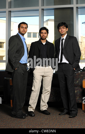 Group of Businessmen standing up inside an office building Stock Photo