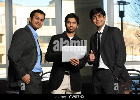 Group of Businessmen standing up inside an office building Stock Photo