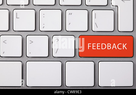 Laptop keyboard and red key "FEEDBACK" on it. Stock Photo