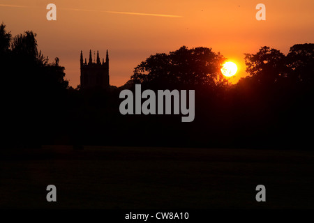 After the warmest day of the year so far the sun sets behind St Martin's Church,Stamford,Lincolnshire. Stock Photo